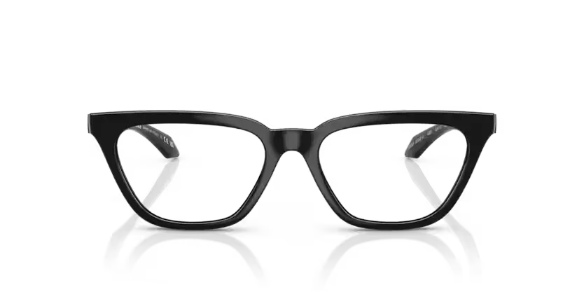 Black cat-eye glasses on a reflective surface with a clear background