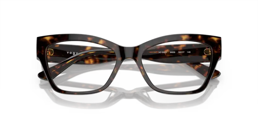 Tortoiseshell glasses with 'Vogue' branding on a white background