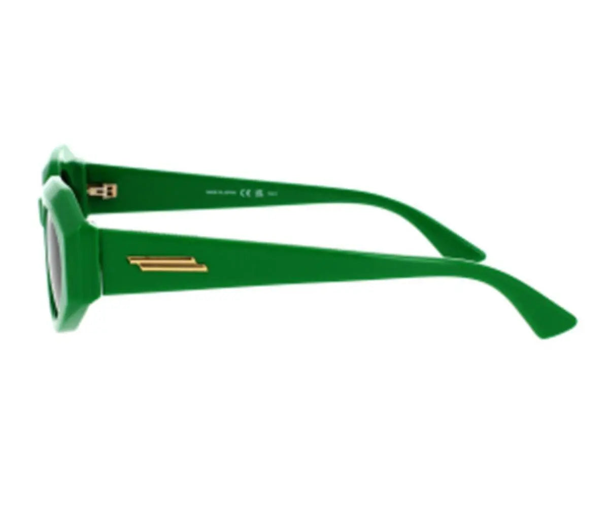 Green sunglasses with gold accents on a white background