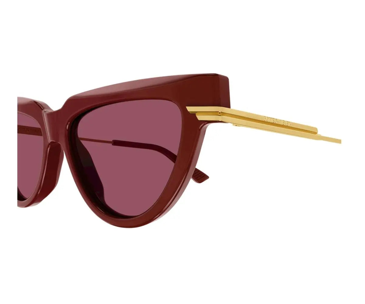 Sunglasses with brown frame and red lenses on a white background