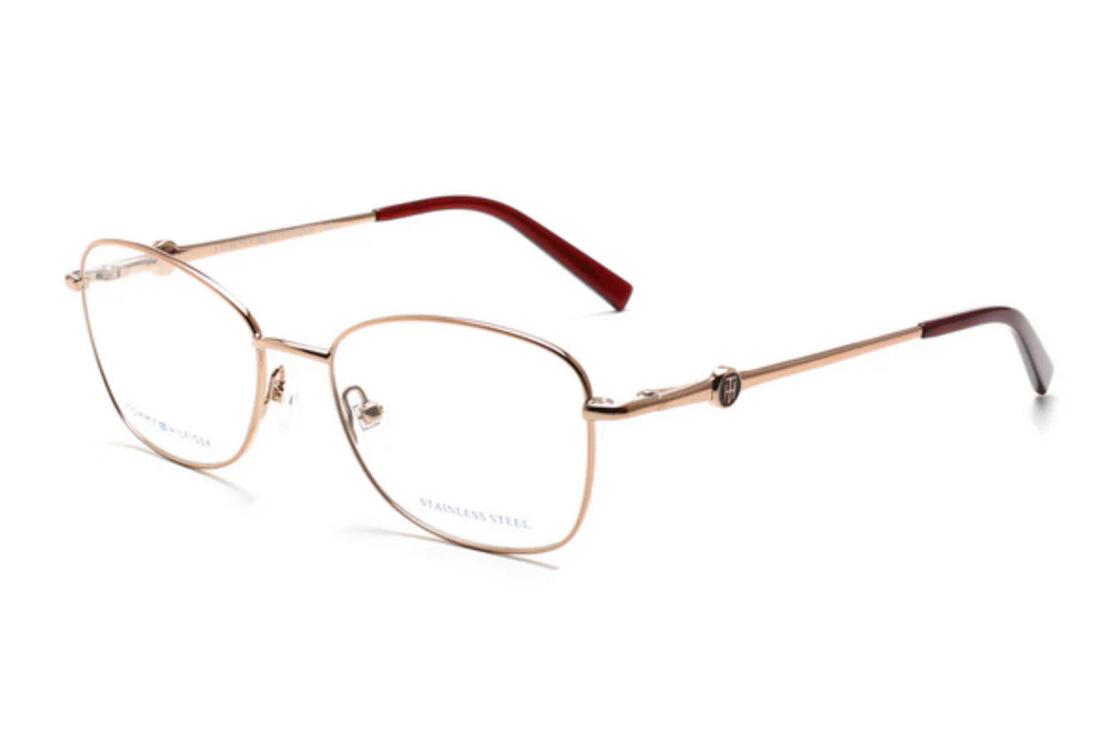 Gold-framed eyeglasses with red accents on a white background