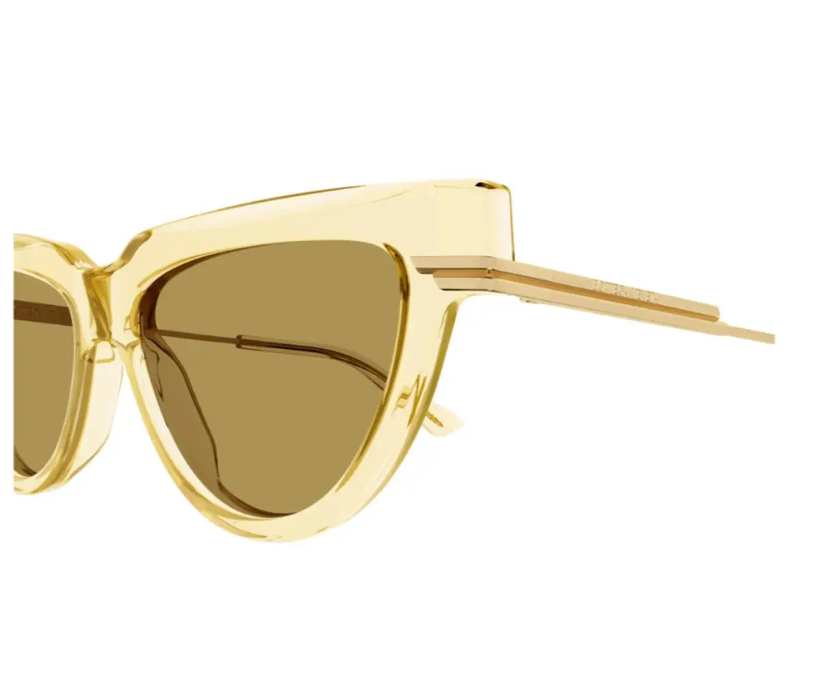 Gold cat-eye sunglasses on a white background