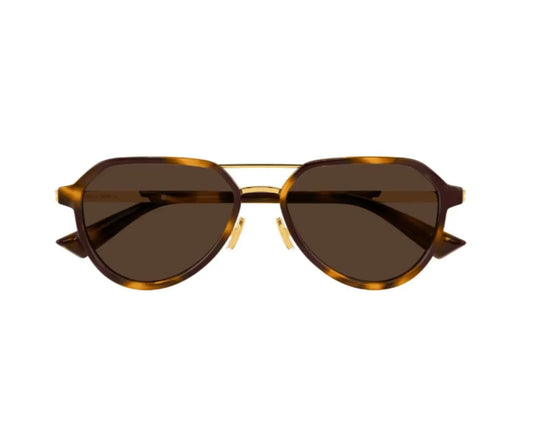 Sunglasses with brown lenses and gold frame on a white background