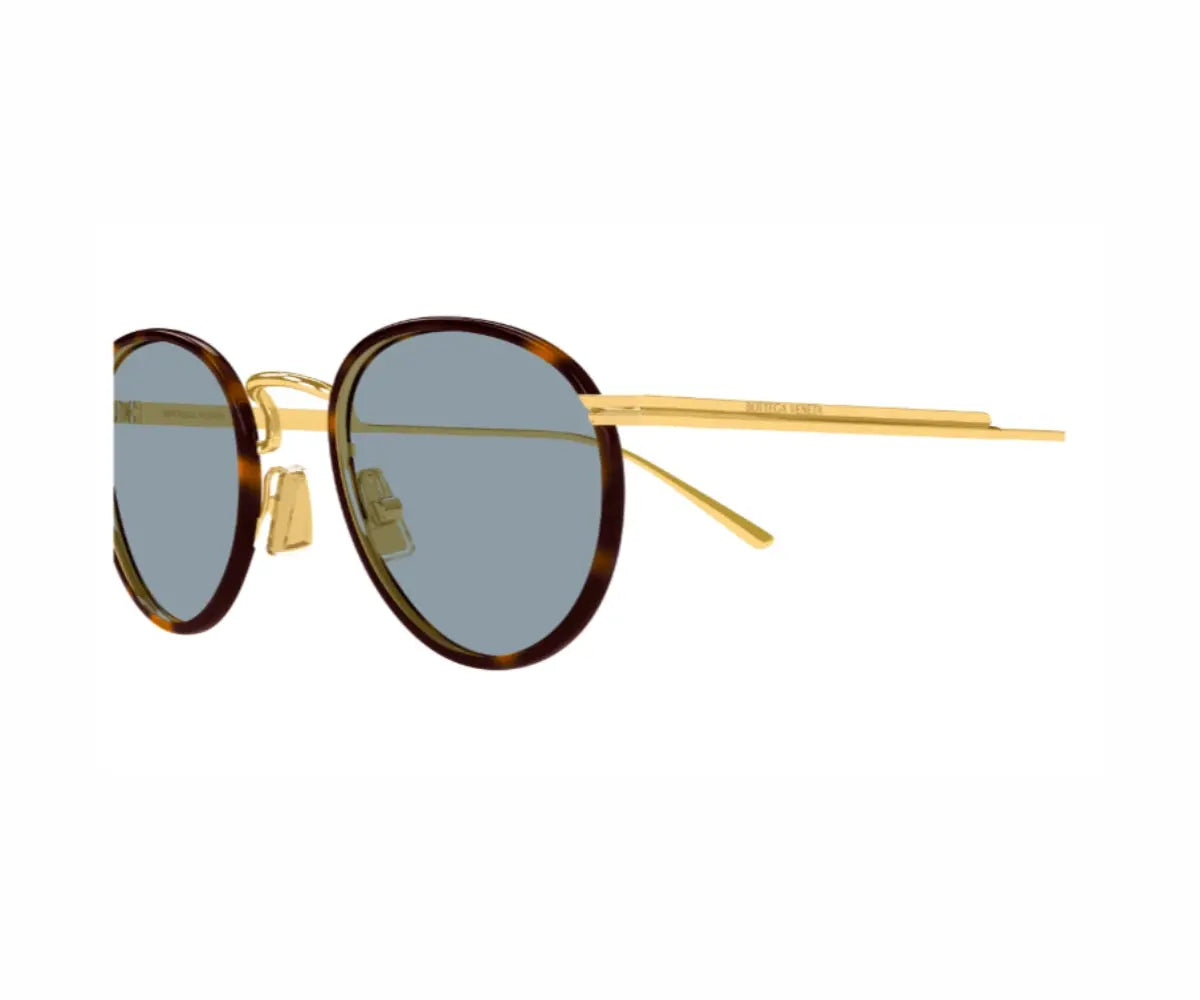 Sunglasses with gold frame and tortoiseshell arms on a white background