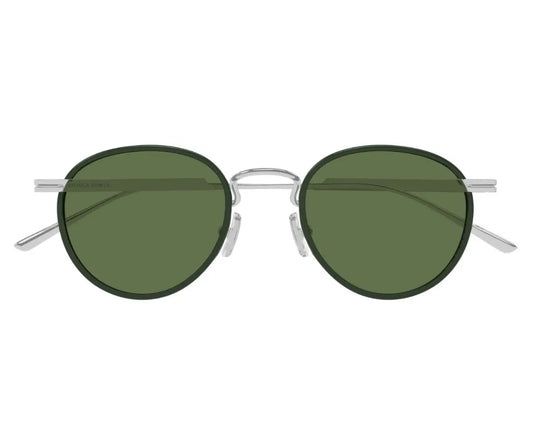 Round sunglasses with green lenses and silver frames on a white background