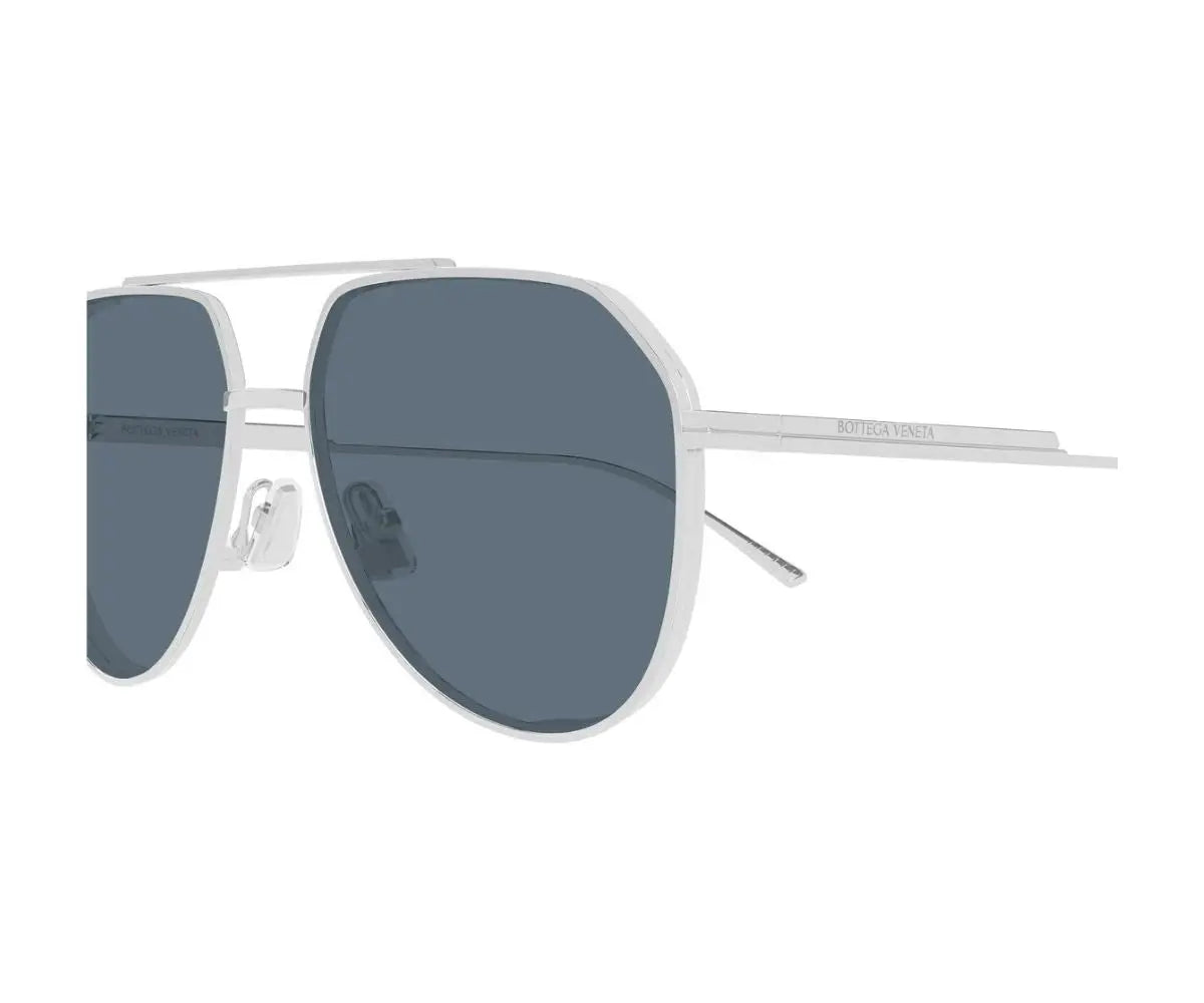 Sunglasses with silver frame and dark lenses on a white background