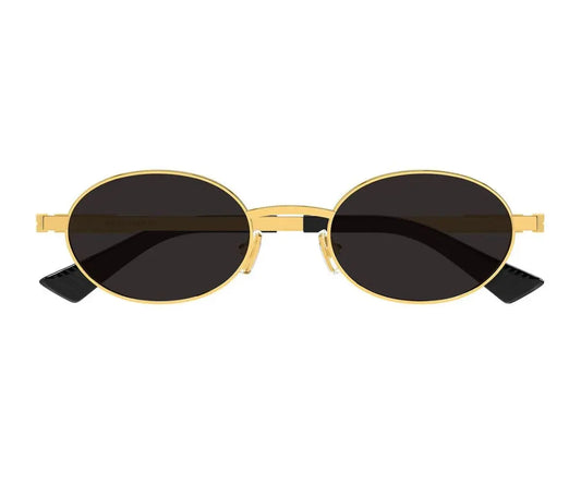 Gold-framed sunglasses with black lenses on a white background