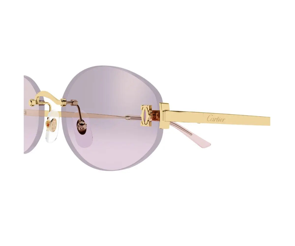 Gold-framed sunglasses with pink lenses on a white background