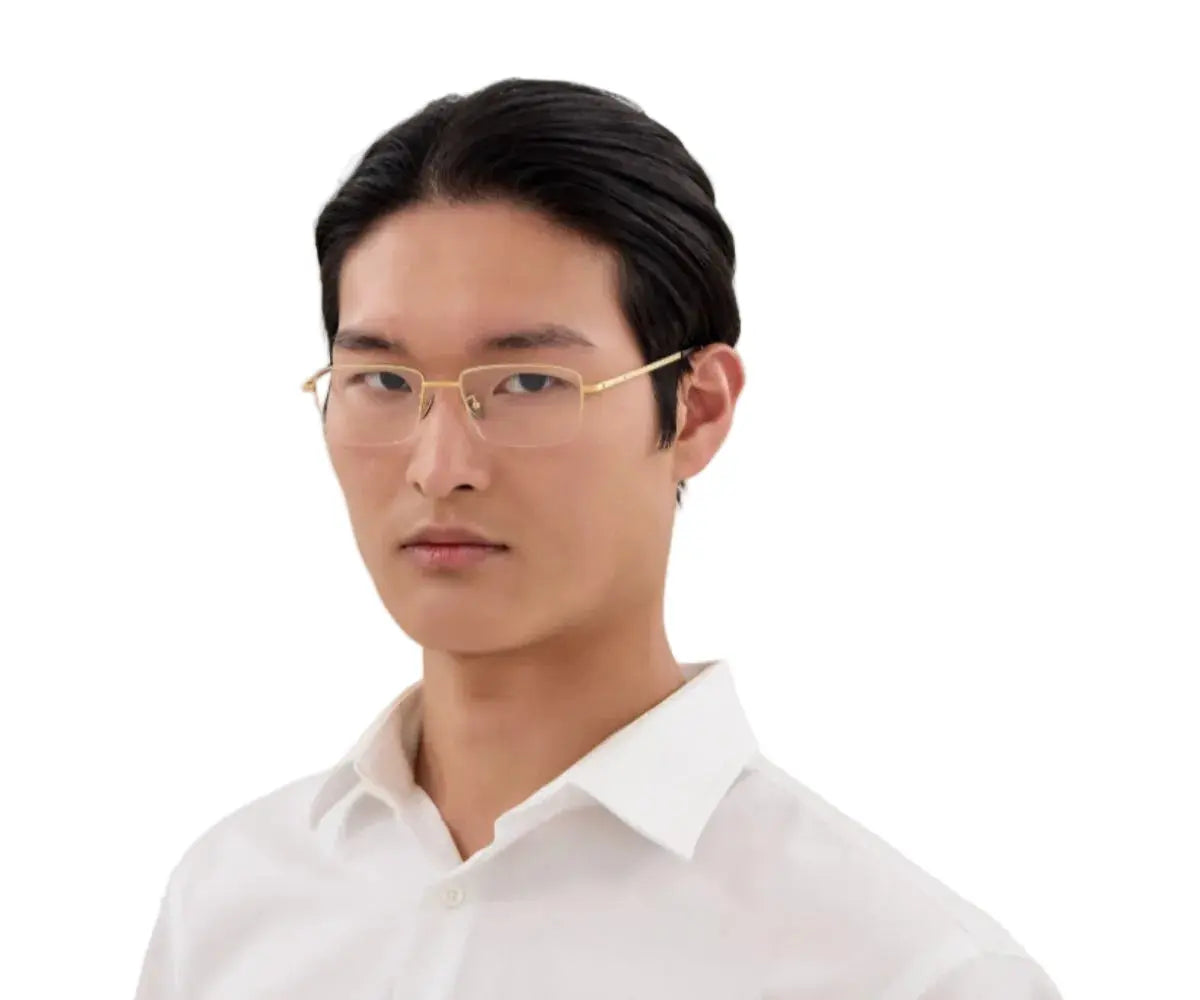 Man wearing gold glasses and a white shirt on a white background