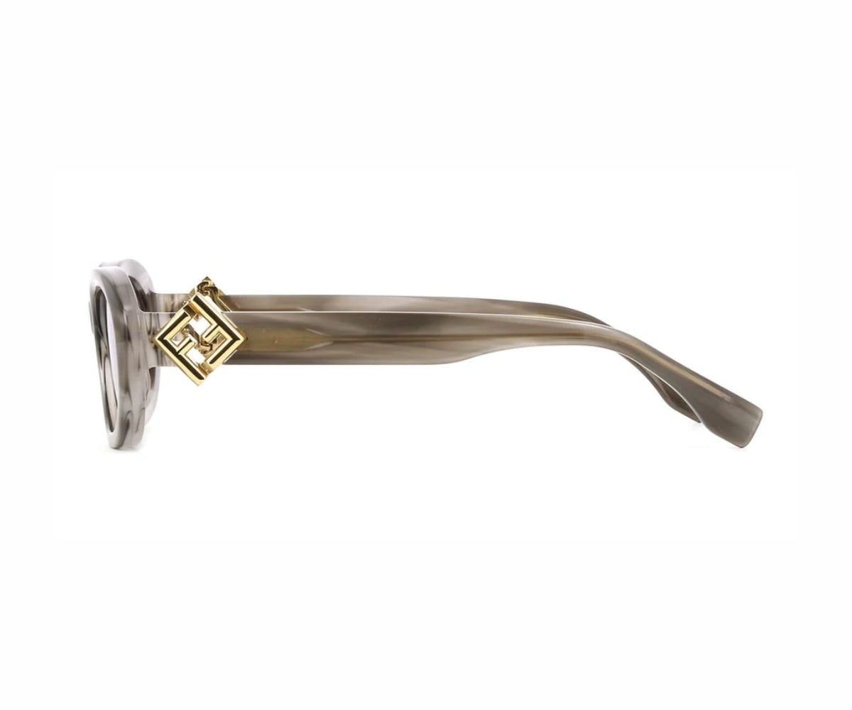 Sunglasses with gold frame and clear lenses on a white background
