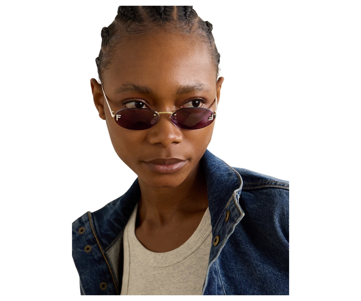 Person wearing sunglasses and a denim jacket on a white background