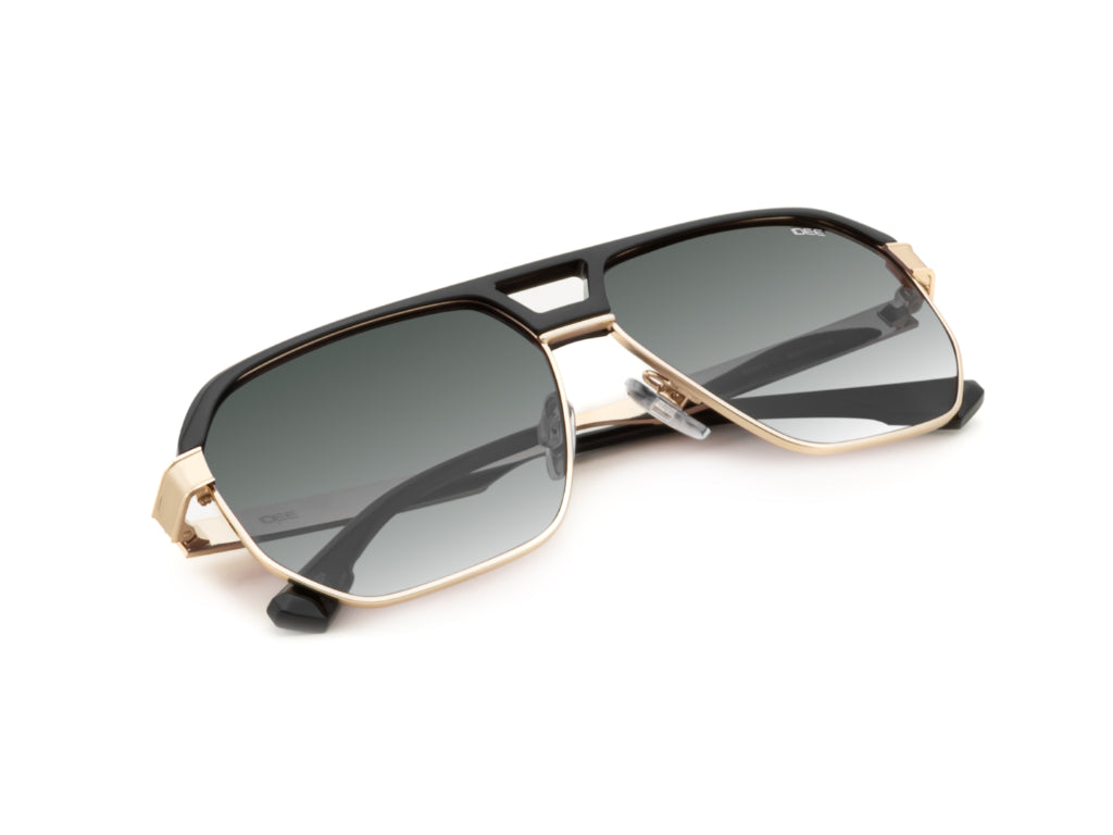 Sunglasses with black and gold frame on a white background