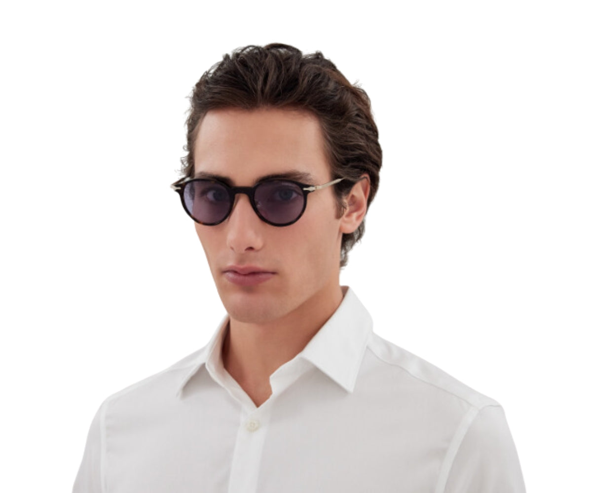 Man wearing sunglasses and a white shirt on a white background