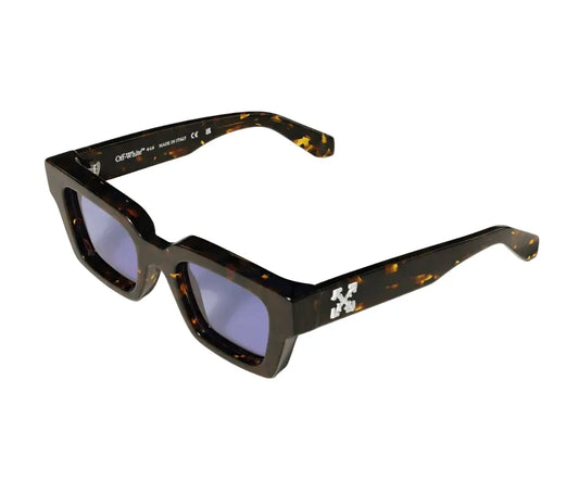 Sunglasses with tortoiseshell frame and blue lenses on a white background