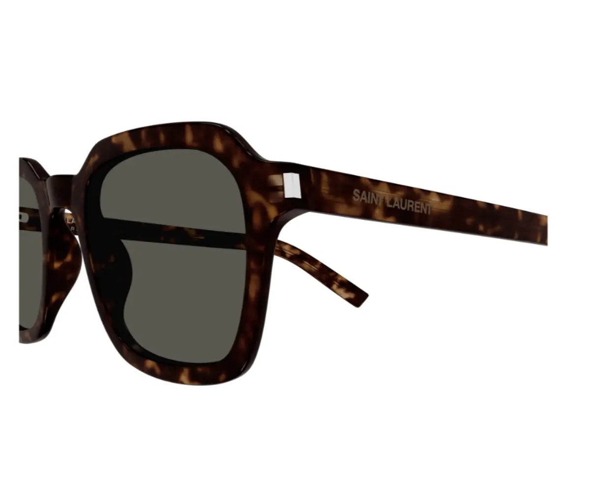 Sunglasses with tortoiseshell frame and dark lenses on a white background