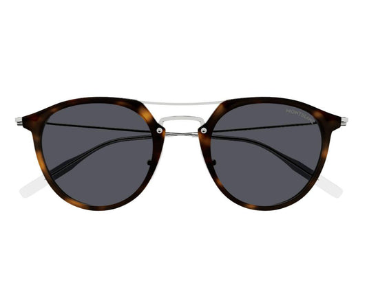 Sunglasses with tortoiseshell frame and dark lenses on a white background