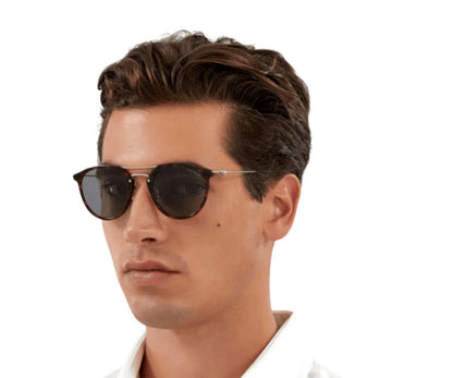 Man wearing dark sunglasses on a white background