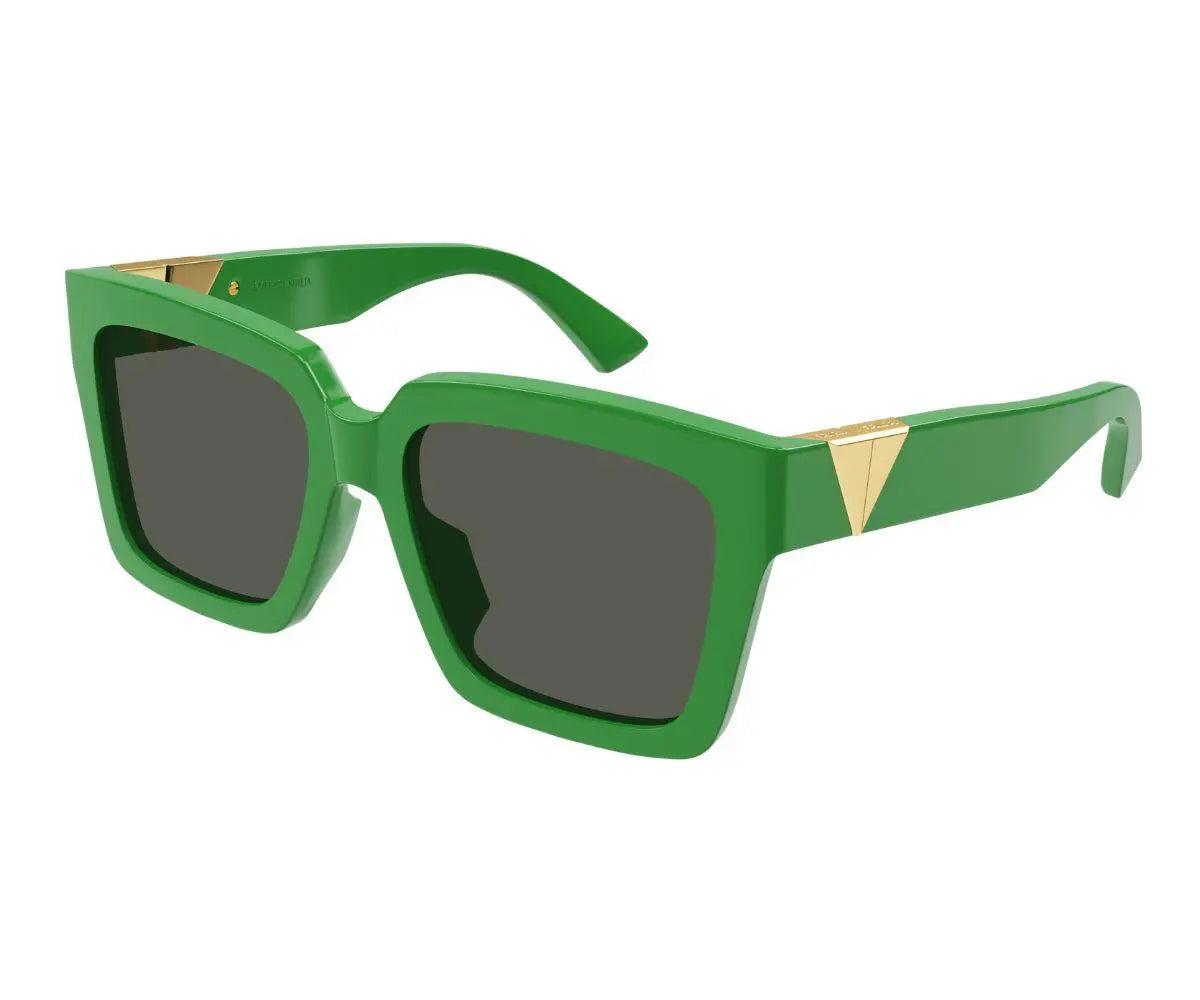 Green sunglasses with gold accents on a white background