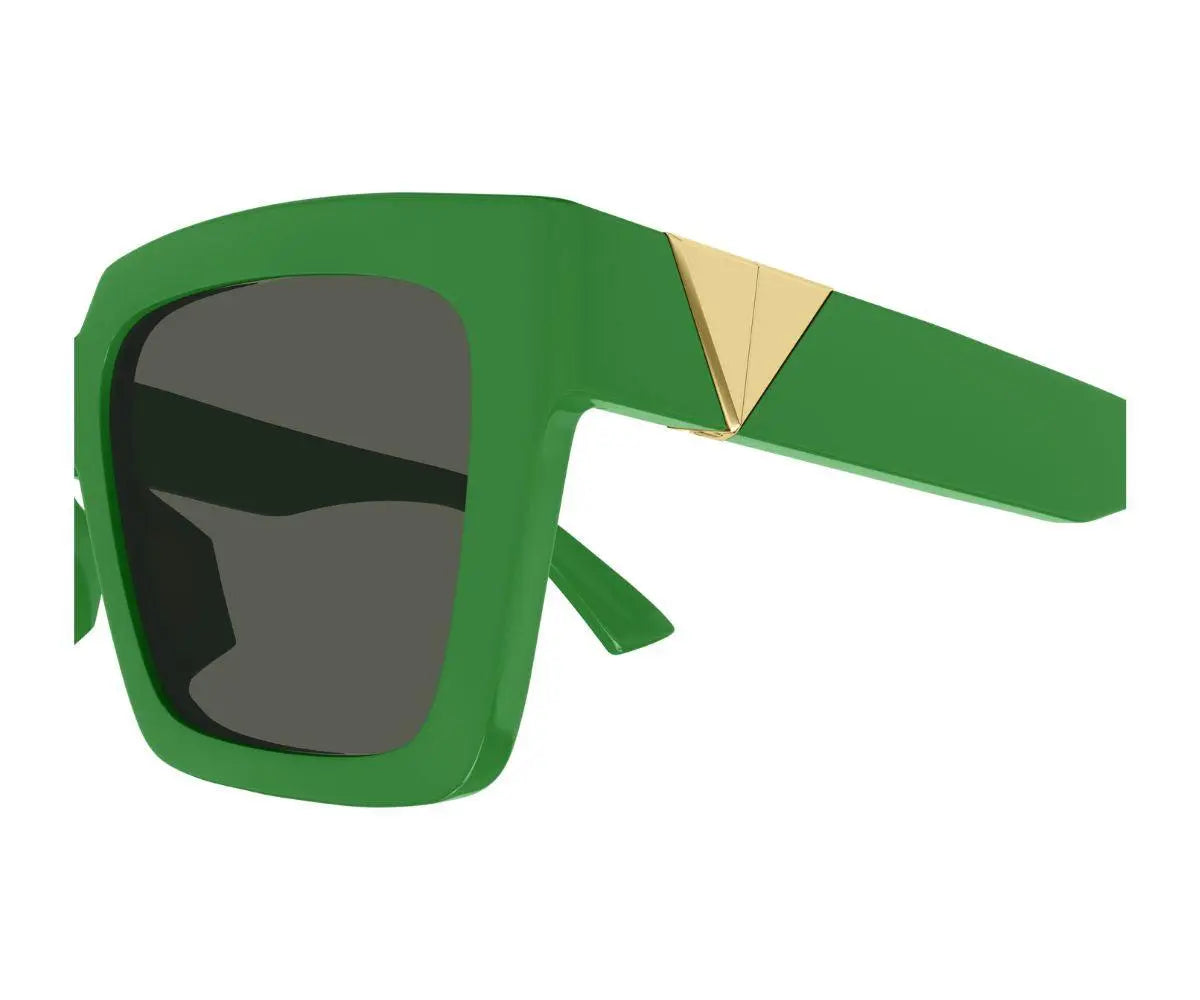 Green sunglasses with a gold accent on a white background