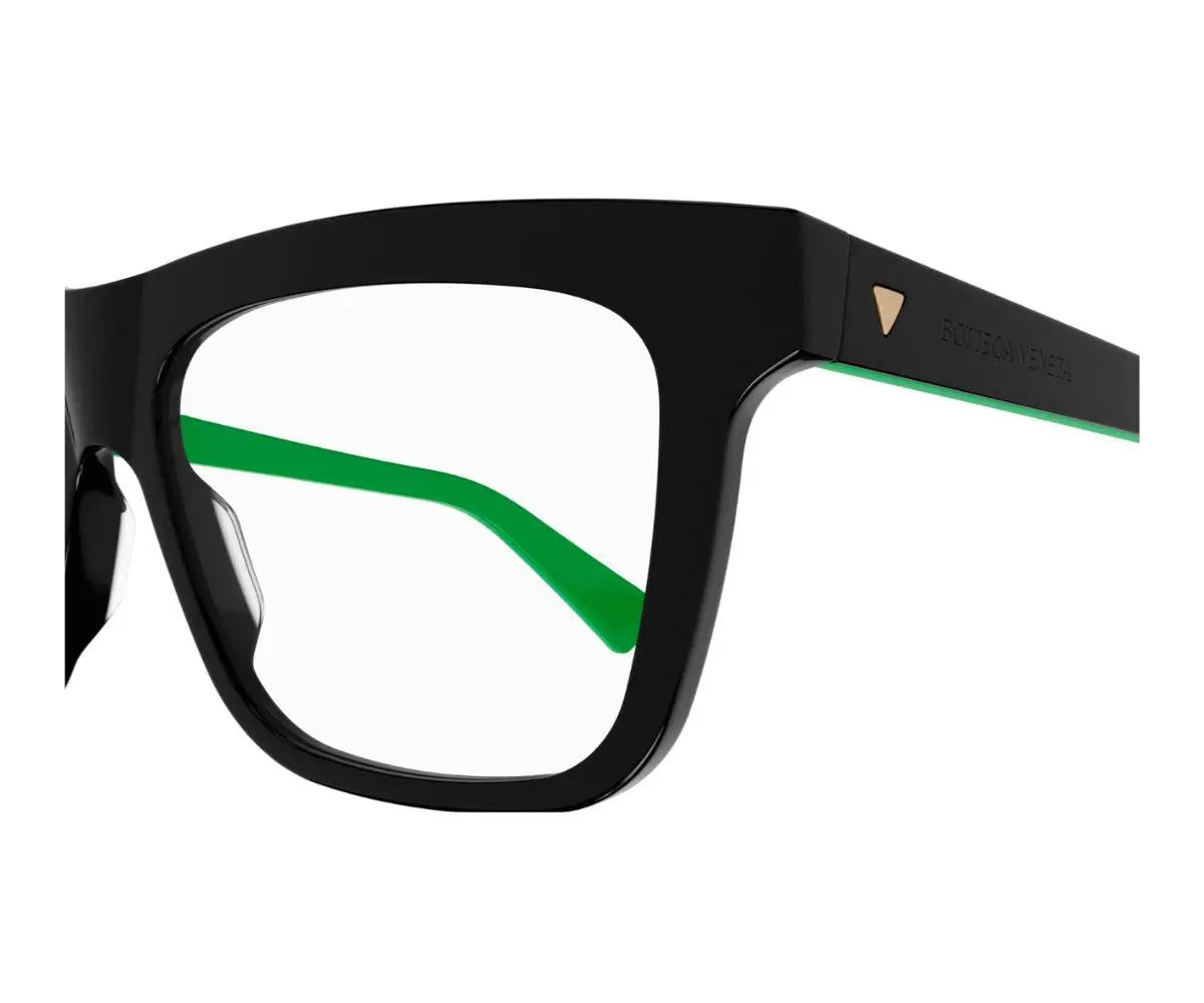 Black and green eyeglasses on a white background
