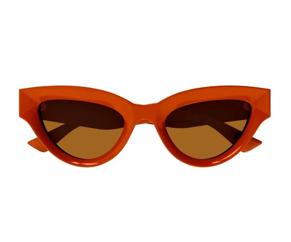 Orange cat-eye sunglasses with brown lenses on a white background