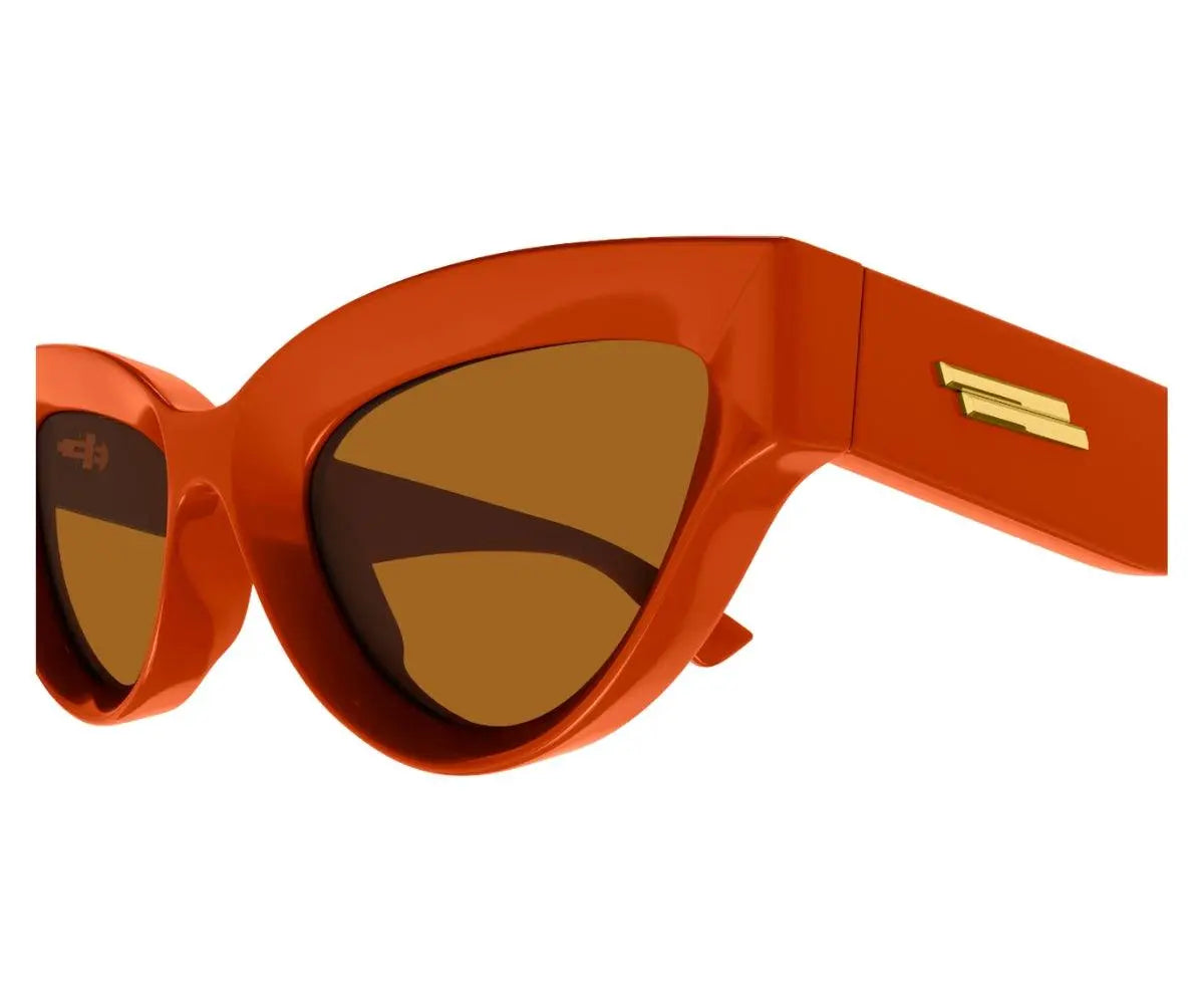 Orange sunglasses with brown lenses on a white background