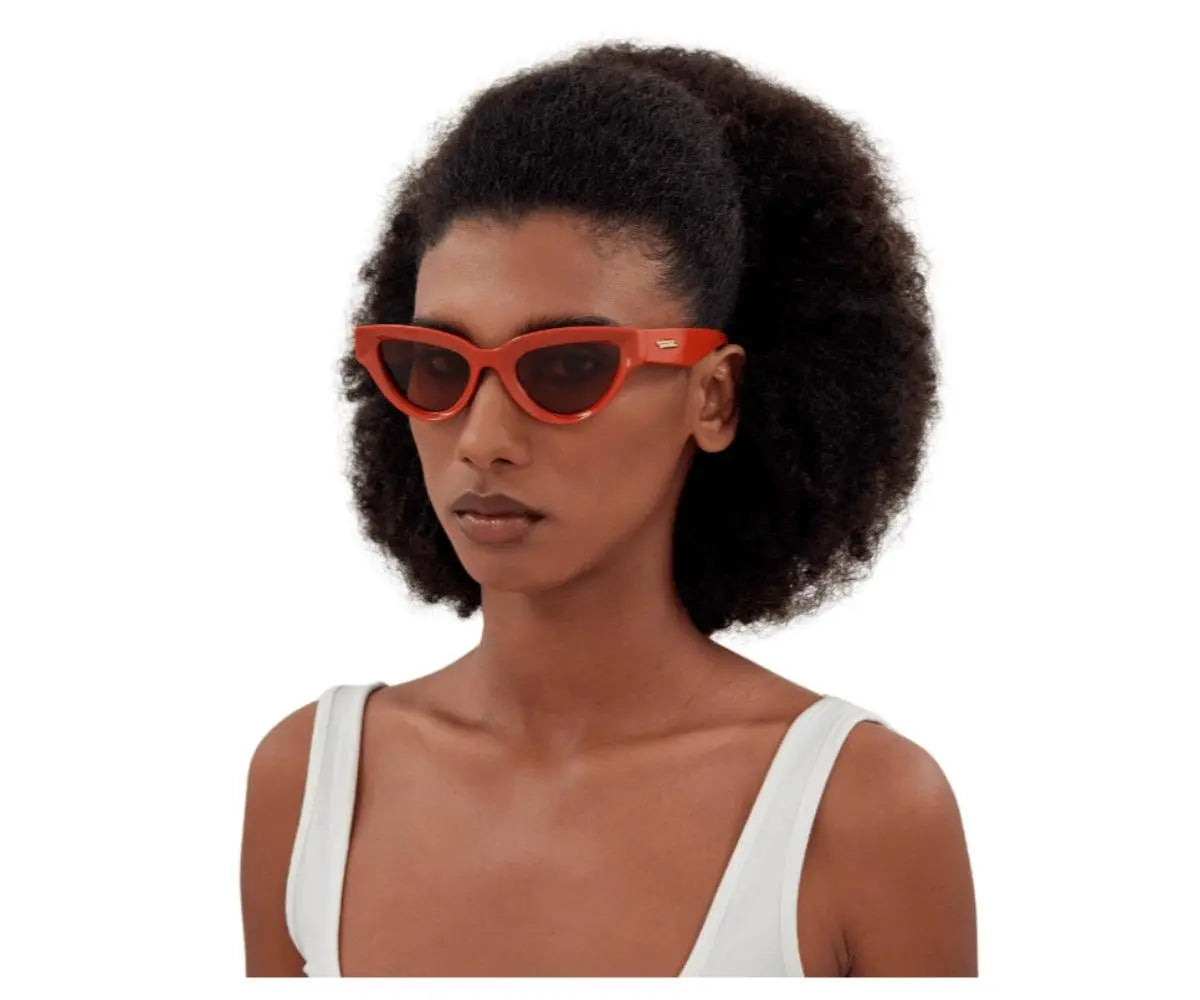 Woman wearing red sunglasses on a white background