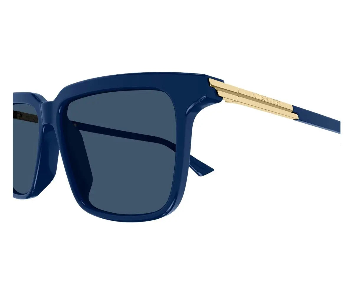 Sunglasses with blue frame and dark lenses on a white background