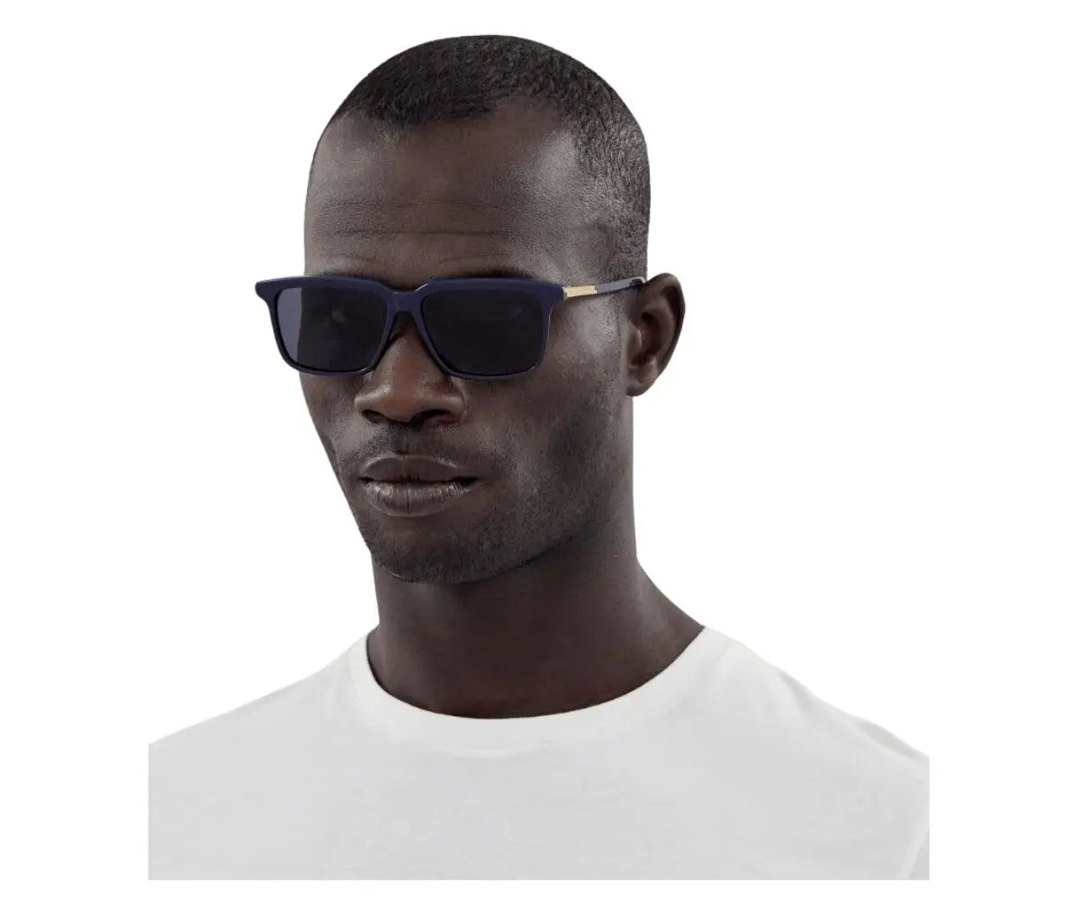 Man wearing dark sunglasses on a white background