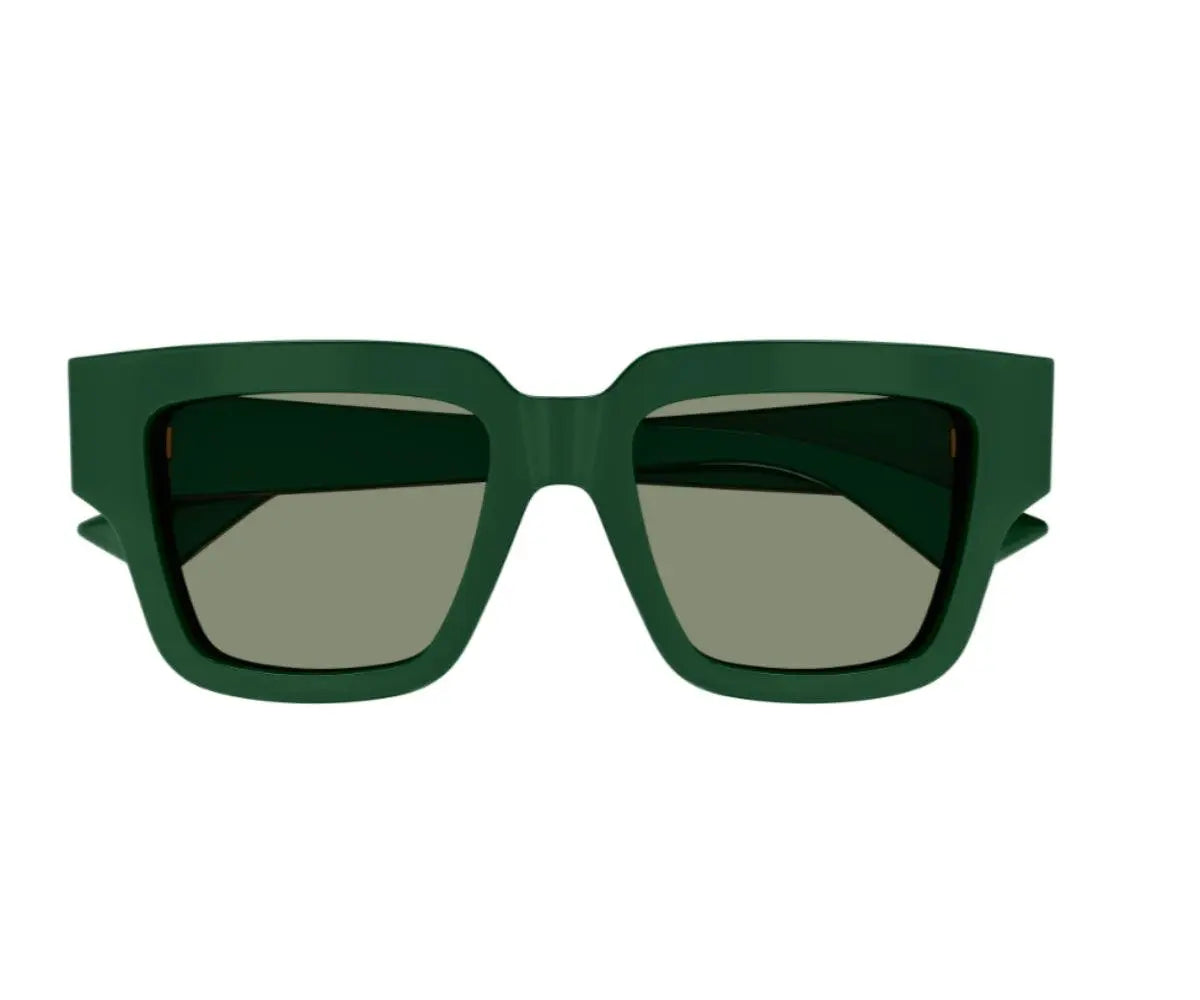 Green sunglasses with dark lenses on a white background