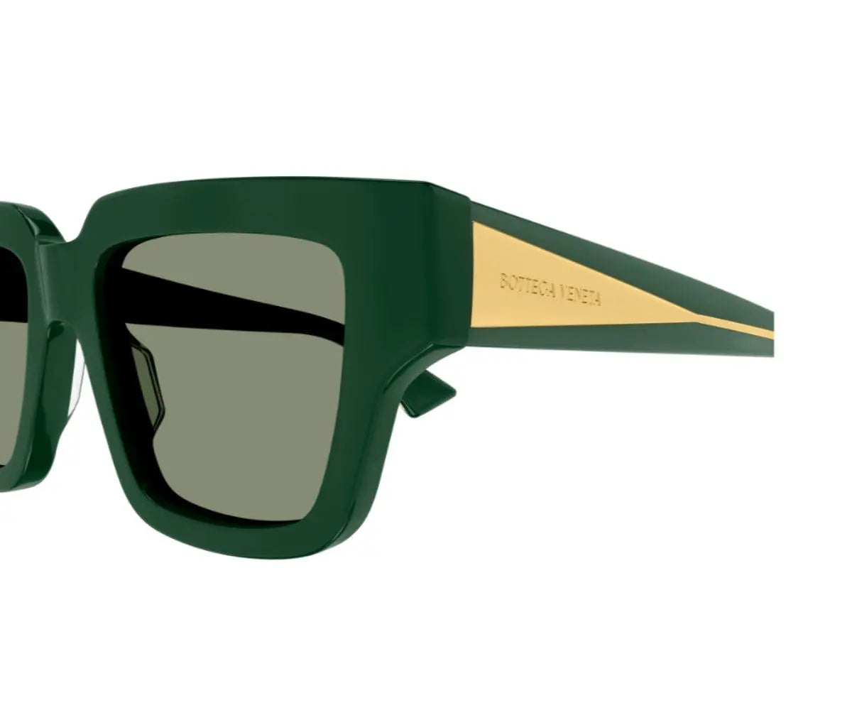 Green sunglasses with gold accents on a white background