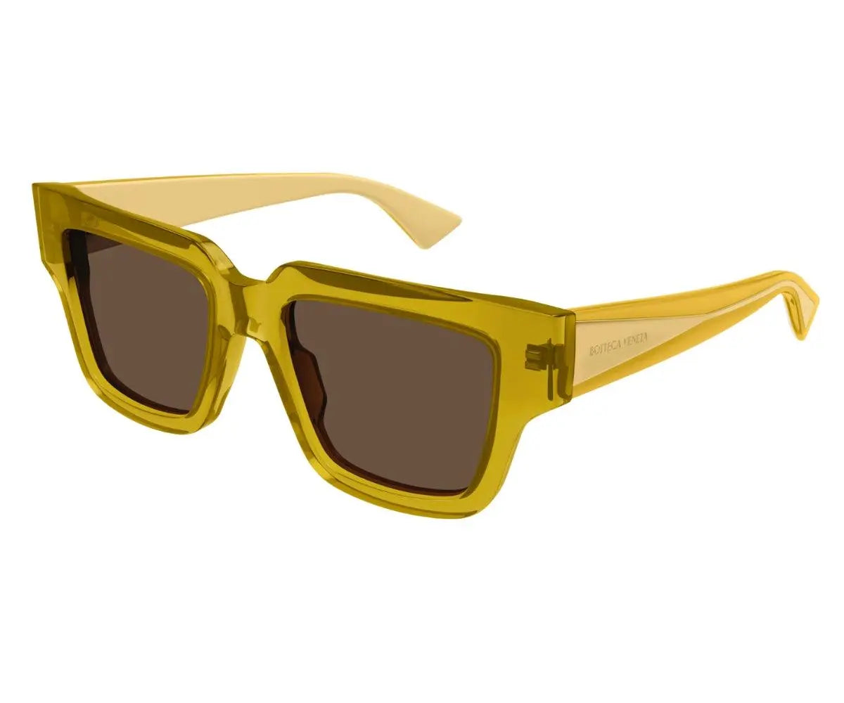 Yellow sunglasses with brown lenses on a white background