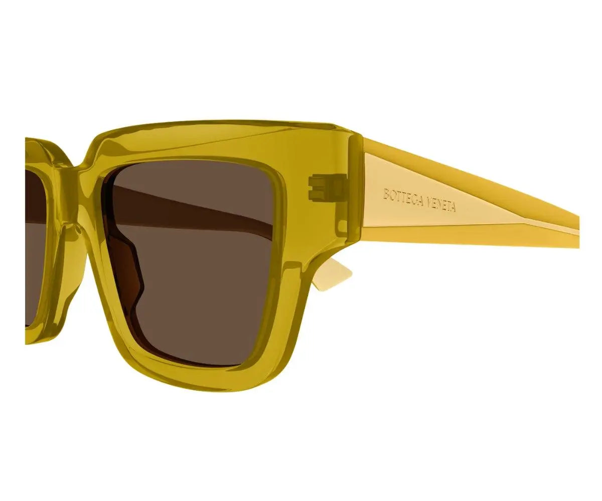Yellow sunglasses with a brand logo on a white background
