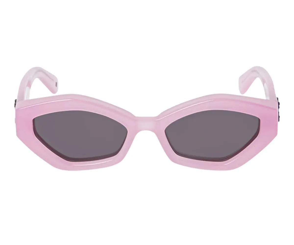 Pink sunglasses with dark lenses on a white background