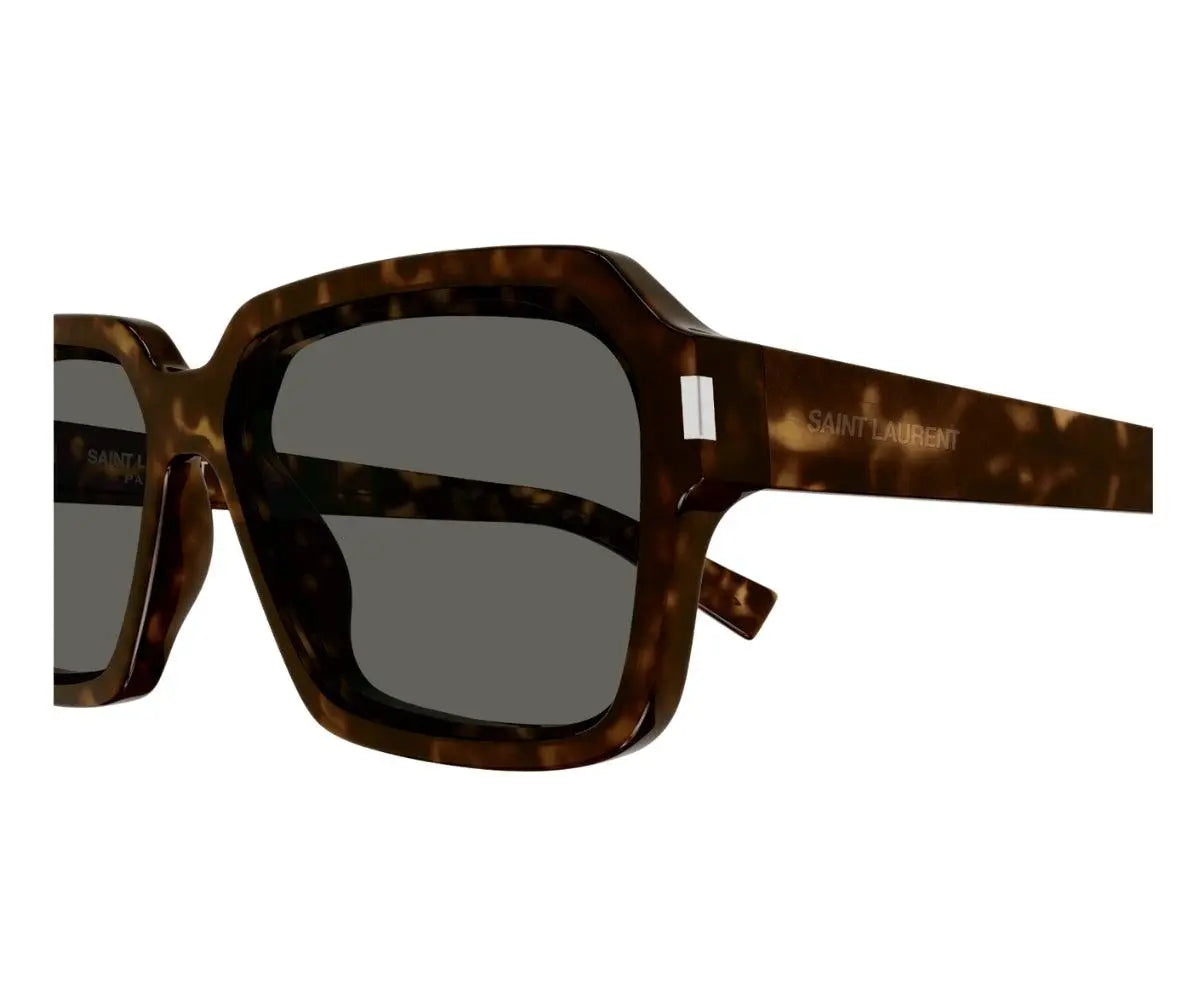 Sunglasses with tortoiseshell frame and dark lenses on a white background