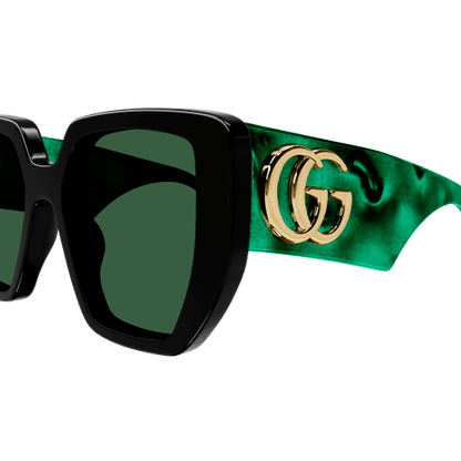 Sunglasses with green satin band and gold logo on a white background