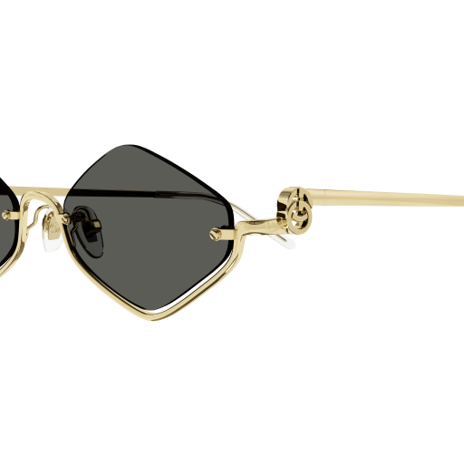 Gold-framed sunglasses with black lenses on a transparent background