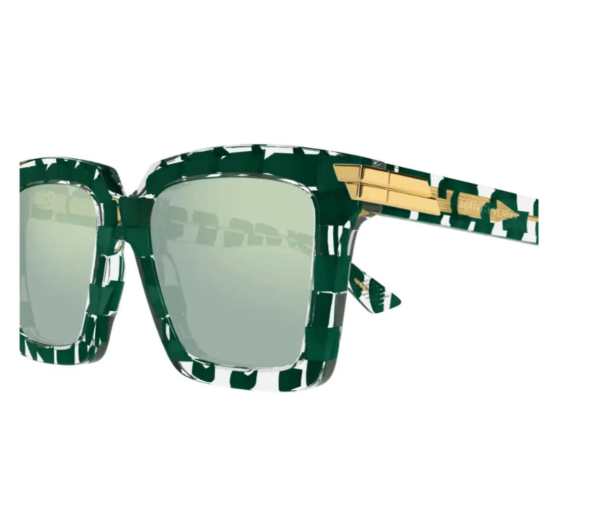 Sunglasses with green and gold frame on a white background