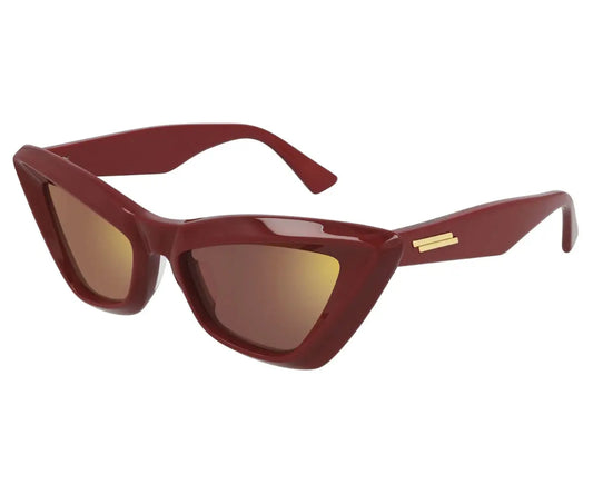 Red cat-eye sunglasses with a gold accent on a white background