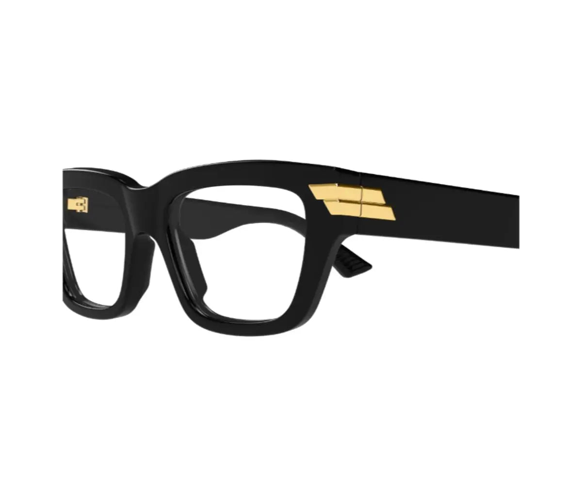 Black eyeglasses with gold accents on a white background