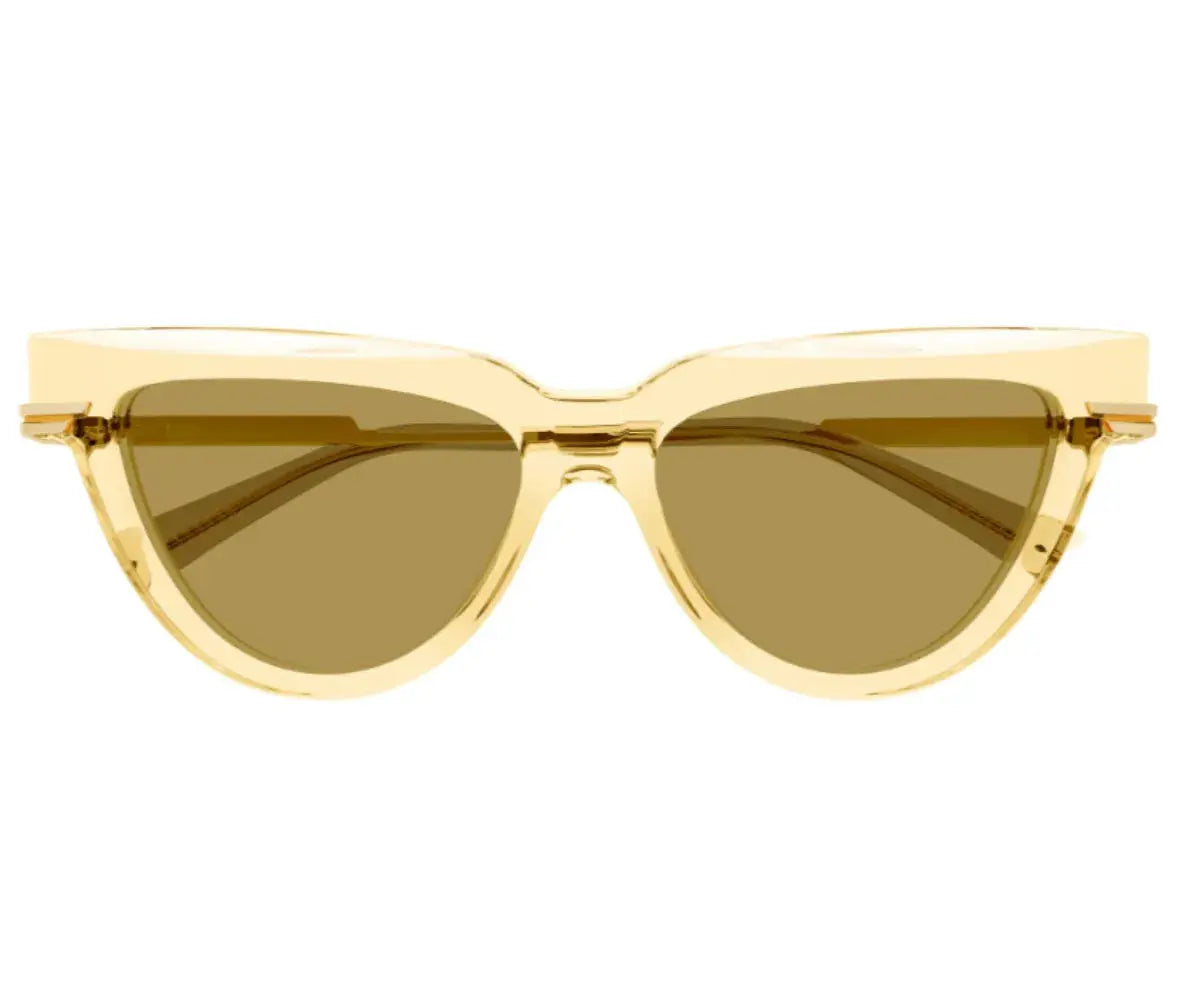 Gold cat-eye sunglasses with brown lenses on a white background