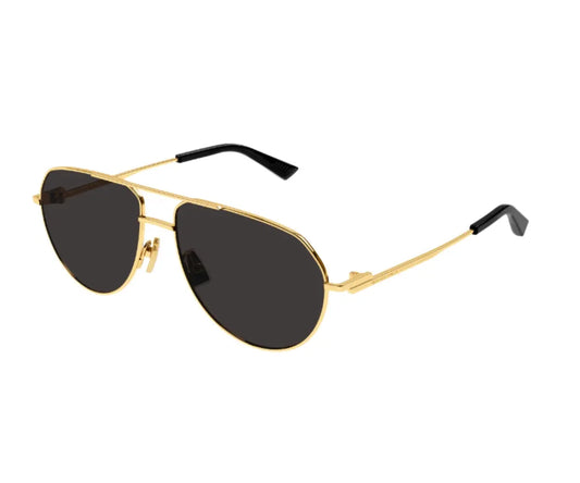 Sunglasses with purple gradient lenses and gold frame on a white background