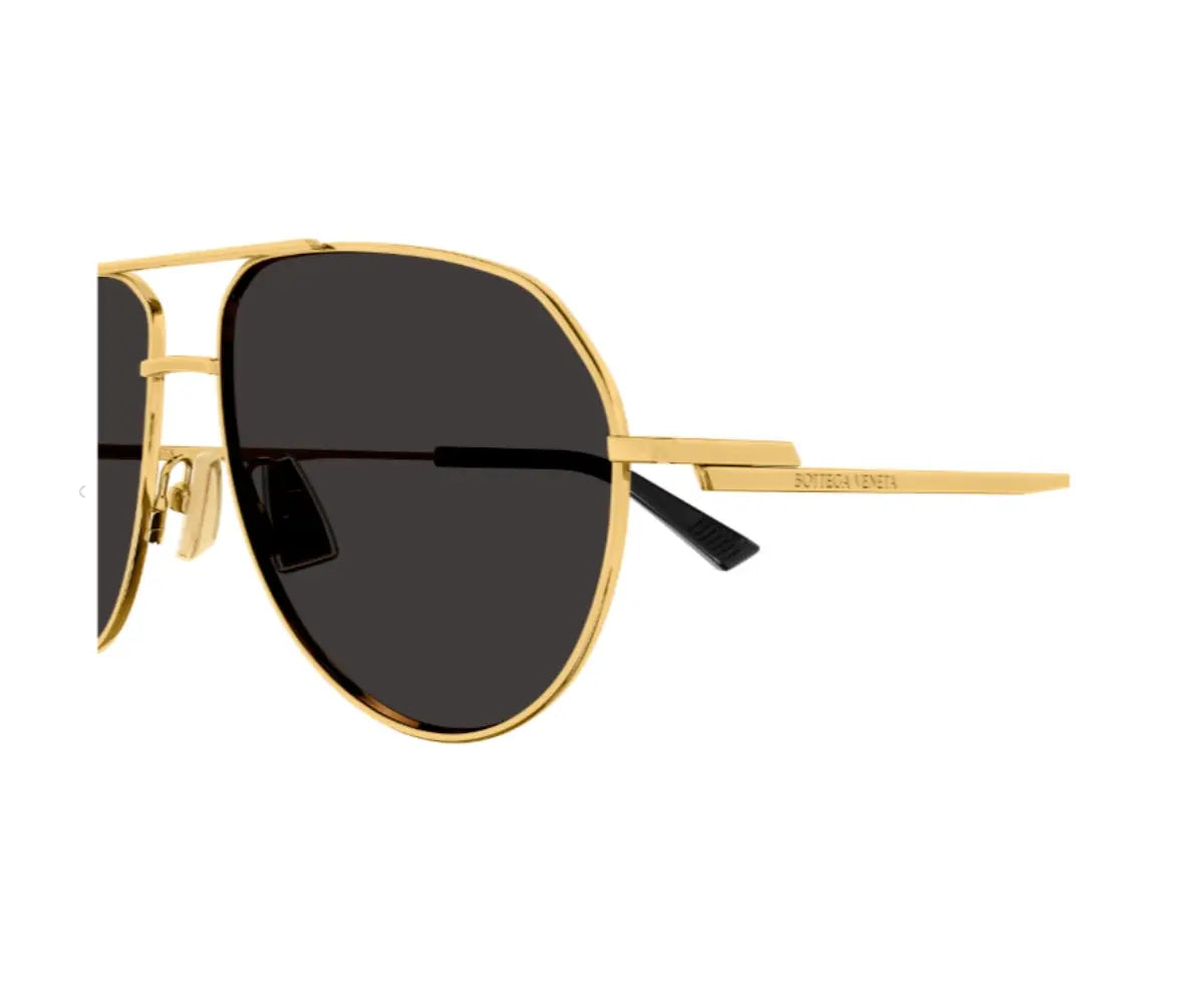 Gold-framed sunglasses with black lenses on a white background
