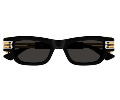 Black sunglasses with gold accents on a white background