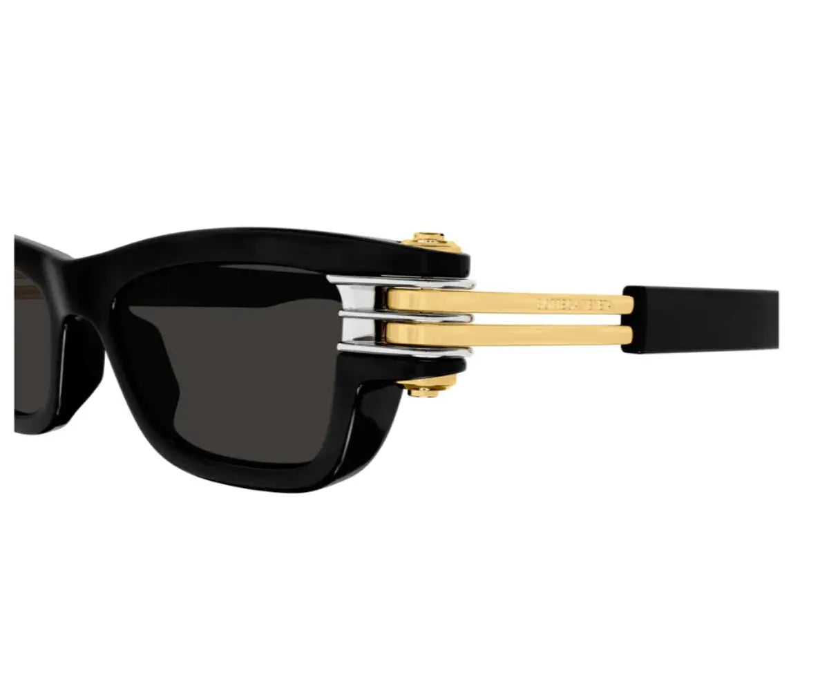 Sunglasses with black frame and gold accents on a white background