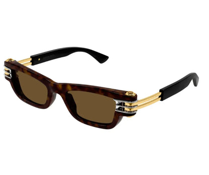 Sunglasses with tortoiseshell frame, gold accents, and dark lenses on a white background