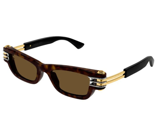 Sunglasses with tortoiseshell frame, gold accents, and dark lenses on a white background