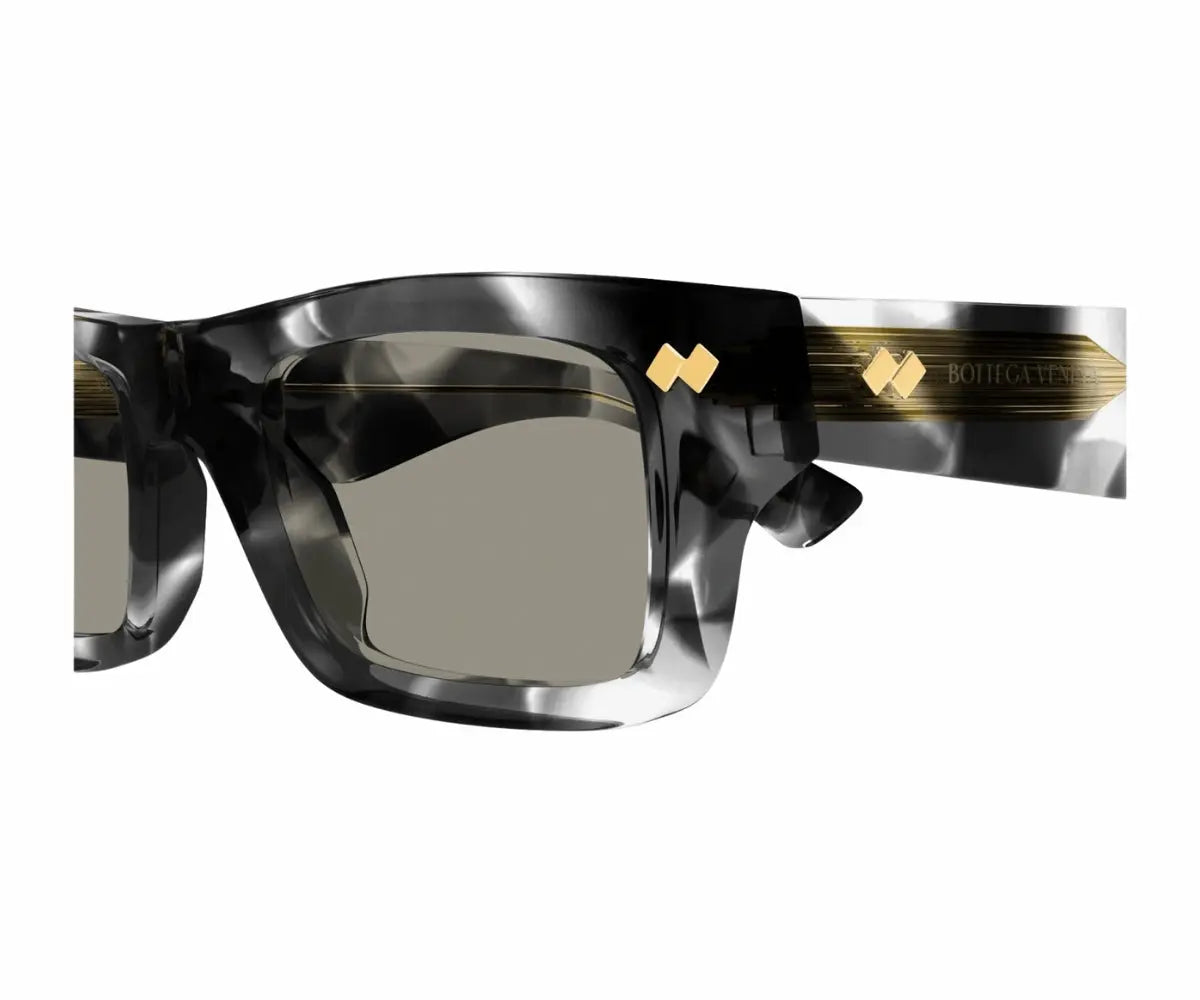 Sunglasses with a black and gold frame on a white background