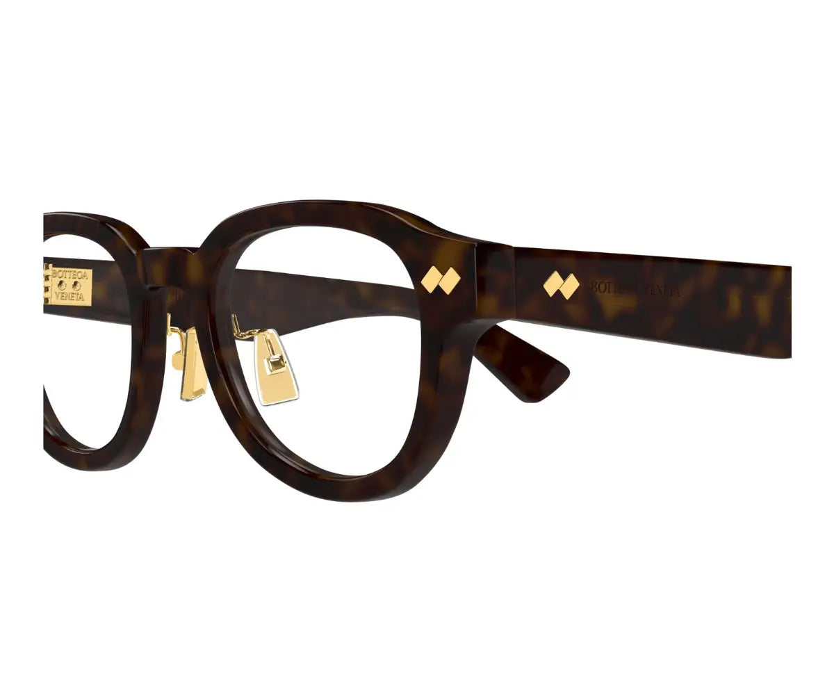 Green eyeglasses with gold accents on a white background