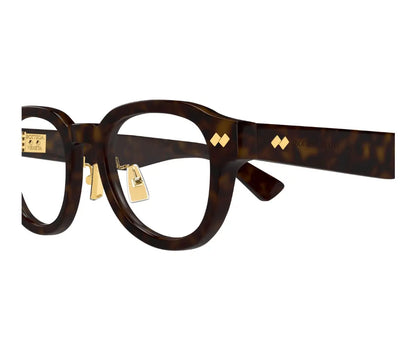 Green eyeglasses with gold accents on a white background